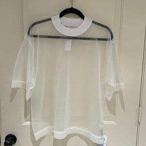 Sheer white tee with ribbing at neckline for a high tight neck.